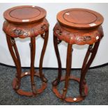 A pair of Chinese hardwood jardiniere stands, circular tops,