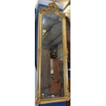 A Rococo style 'gilt'wood wall mirror/looking glass, of tall and slender proportions,