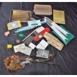 A collection of needlework items including needle cases,