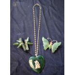 A green stone heart pendant, possibly jade, with applied initials RL,