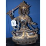 A bronzed metal figure, seated deity, 28.