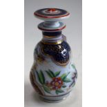 A German scent bottle and stopper, decorated with flowers and foliage on a flow blue ground,