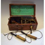 A vintage Arnold and Sons Magneto Electric Therapy Machine, hand crank action, wooden case, c.