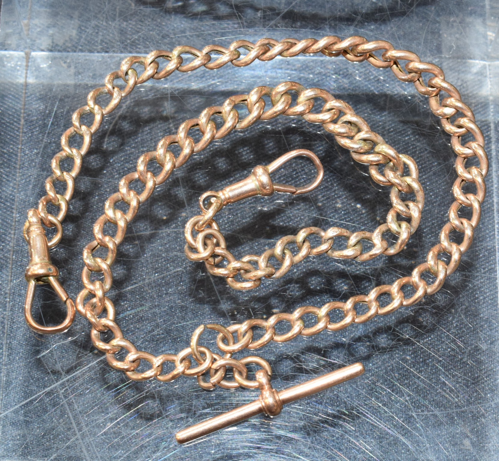 A 9ct gold graduated link Albert chain, T-bar, spring clip terminals, 43cm long, 21.