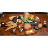 A large carved wooden dish, containing a wide variety of turned and carved fruit,