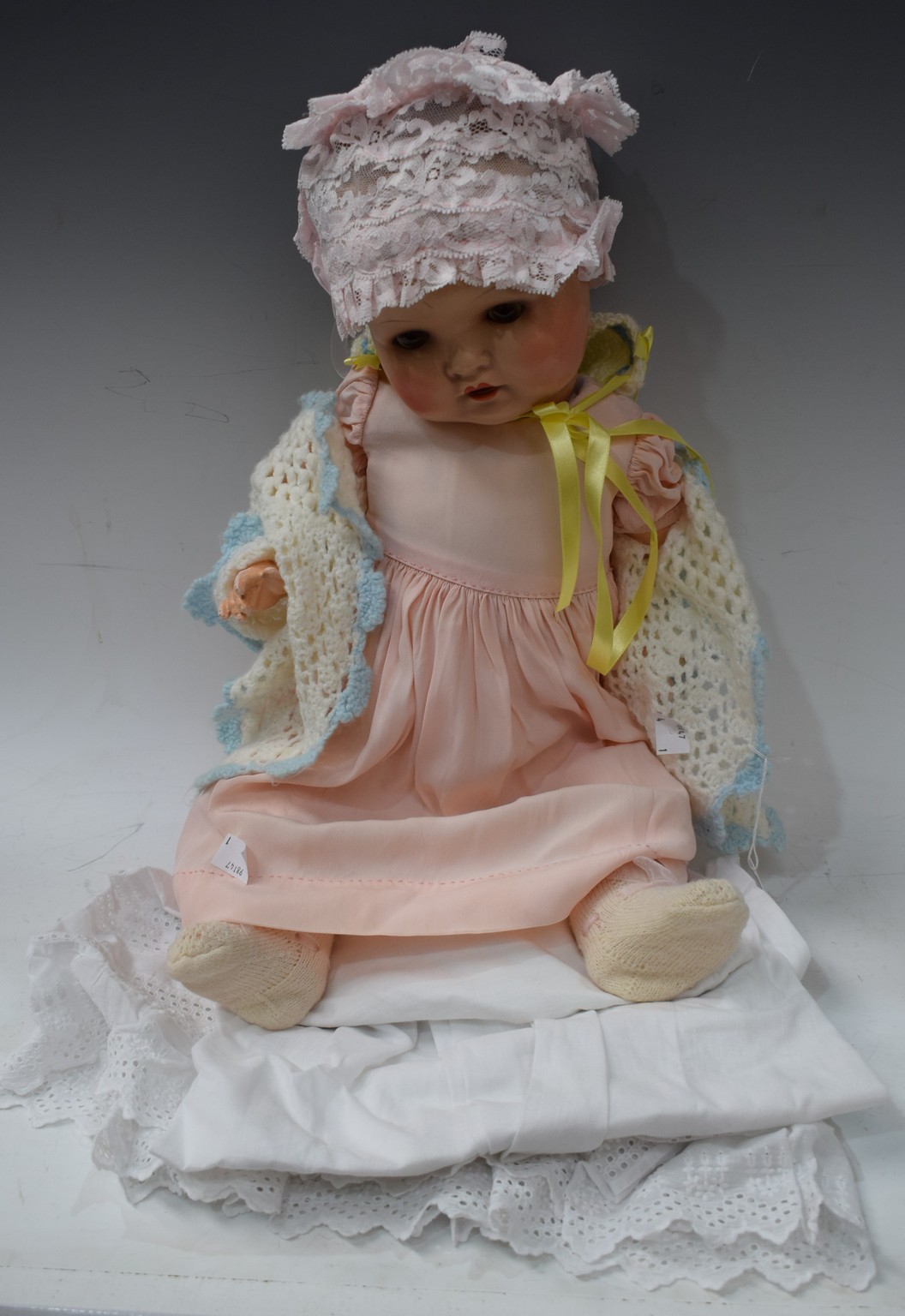 An early 20th century German composite doll, sleeping brown eyes, open mouth and teeth,