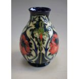 Ceramics - a Moorcroft vase, poppy design, blue ground,