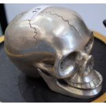 Macabre - a silver coloured metal desk model, skull, hinged jaw,
