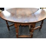 A 19th century oak gateleg table, elliptical top with fall leaves, shaped apron, turned supports,