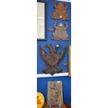 A carved plaque, two headed eagle; a pair of cast metal wall mounted frogs; another,