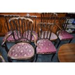 A pair of early 20th century mahogany open elbow chairs;