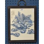 A Chinese blue and white plaque, decorated with an elder in a blossoming pagoda landscape,