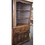 A 17th century style oak floor standing corner cupboard,