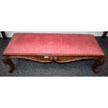 A Victorian mahogany footstool, drop-in cushion, shaped scrolling serpentine frieze,