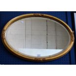 A 19th century oval gilt framed bevelled mirror,