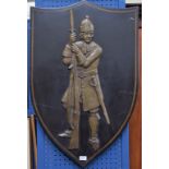 A decorative shield shaped plaque, man of arms, 93.
