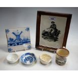 An early Delft tile, 13cm wide; a moulded pottery framed print,