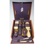 An early 20th century lady's leather vanity case, cut glass jars,