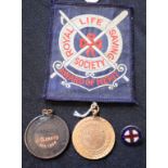 A Royal Life Saving Society award of merit; a similar cloth badge; a similar medallion,