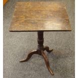 A George III oak tilt top tripod table, rectangular top, turned column, cabriole legs.
