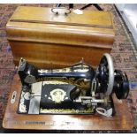 A 19th century hand cranked sewing machine, possibly by Frister & Rossmann, fiddle base, no.