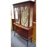 An Edwardian flame mahogany display cabinet, outswept cornice,