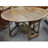 An 18th century oak gateleg dining table, oval top,
