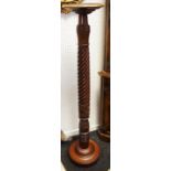 A mahogany torchere, dished circular top, rope twist column, circular socle and base, bun feet.