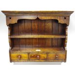 A country oak wall shelf of small proportions, stepped cornice,