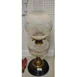 An early 20th century oil lamp, clear glass reservoir,