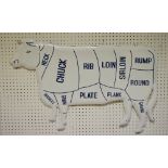 An enamelled butchers sign, of a cow, showing the meat cuts,