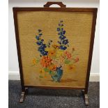 An oak framed woolwork firescreen