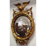 A reproduction Regency gilt framed convex wall mirror, eagle pediment.