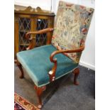 A George I style open armchair with tapestry upholstered back, shaped arms, cabriole legs.