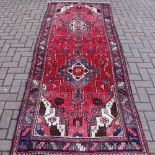 A hand woven Hamadan carpet, geometric and floral designs in tones of steel blue,