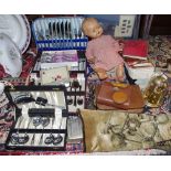 A celluloid baby doll; an anniversary clock; military history collector's cards; a mat;