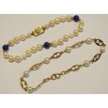 A pearl and Lapis Lazuli bracelet with a yellow metal clasp set with a central round diamond,