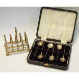 A toast rack, Sheffield 1909, 149g; a set of six silver coffee bean spoons, cased, Sheffield 1950,