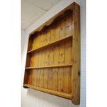 A pine wall mounted plate rack