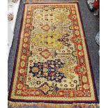 A hand woven Middle Eastern throw rug decorated with stylized flora in hues of cobalt,