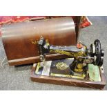 A cased hand powered Singer sewing machine