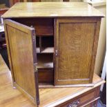 An oak desk cabinet, two doors opening to an arrangement of four drawers and five pigeonholes. 48.