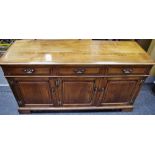 A Simpson's of Norfolk cherry wood sideboard, moulded oversailing top, three short drawers,