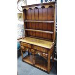 A Titichmarsh & Goodwin oak dresser of small proportions, outswept cornice,