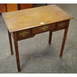 An oak lowboy, moulded top, one long drawer flanked by two short to frieze, chamfered square legs.