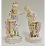 A pair of German figures, of a girl playing with dominoes and boy playing with playing cards,