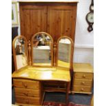 A modern pine bedroom suite comprising a Duchers wardrobe, two doors over two long drawers,