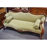 A Victorian mahogany scroll arm sofa, foliate carved top rail, padded back, padded arms ,