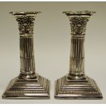 A pair of silver plate Corinthian column candlesticks