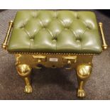 A 19th century style brass footman, green Chesterfield buttoned leather upholstery, two handles,